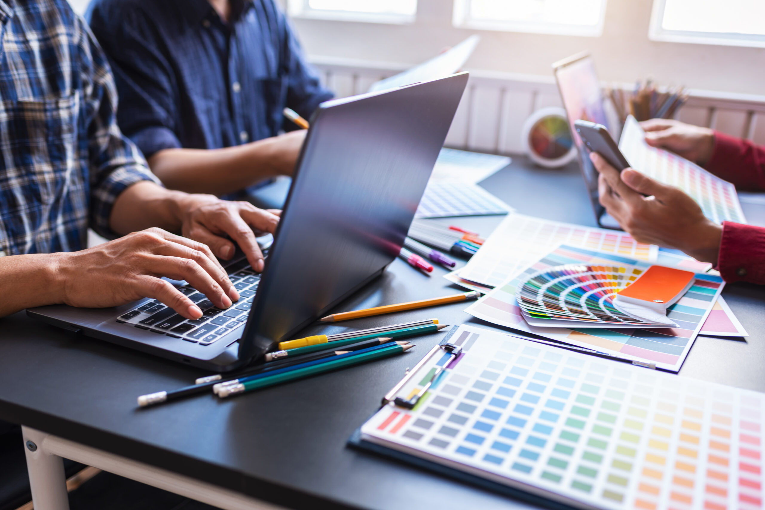 Group of artists brainstorming planning partnership strategy to Group of artists brainstorming planning partnership strategy to coworkers in creative office. Teamwork Concept.